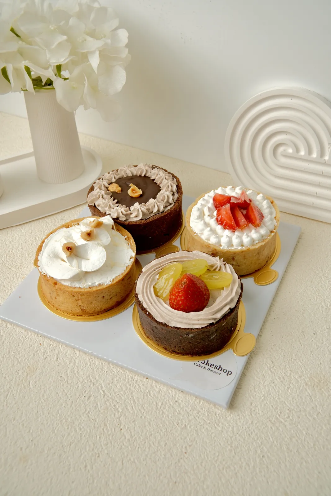 Petite cake Itacakeshop di atas alas emas: choco hazelnut, strawberry, dan vanilla